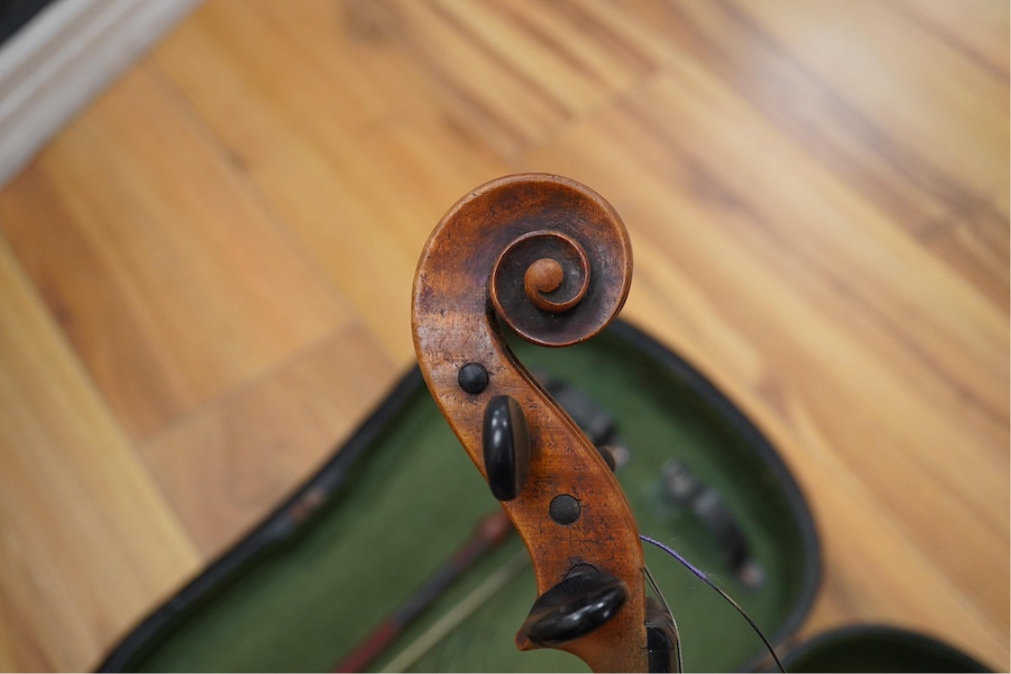 A late 19th cased century French unmarked violin and bow, body 35cm high.